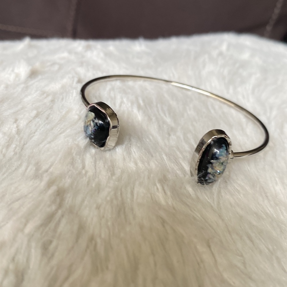 Silver cuff bracelet with black/opalescent stone